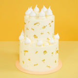 2 Tier White Gold Wedding Cake with smooth buttercream, white meringues, and edible gold leaf by Crumbs & Doilies